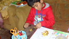 Diego doing  his maths by counting beans, literally