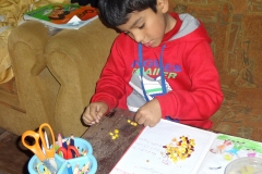 Diego doing  his maths by counting beans, literally