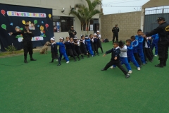 Police dogs & children racing through the tunnel of legs